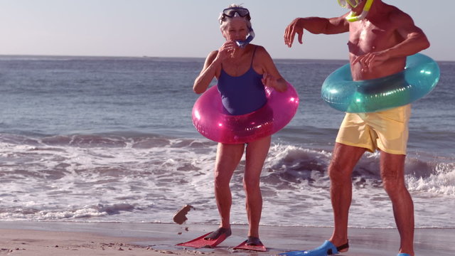 Happy senior couple having fun with water