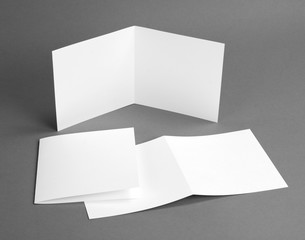 White empty closed card on grey to replace your design.