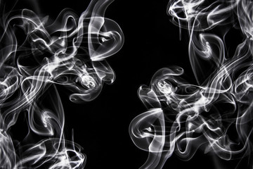 Black smoke swirls over the black background