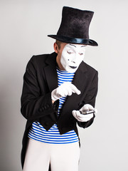 mime with smartphone. Concept of  April Fools Day.