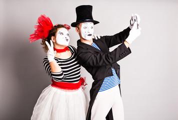 Funny couple of mimes taking a selfie photo, April Fools Day