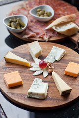 Wine appetizers set: meat and cheese selection, grapes and bread