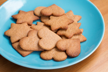 Tasty homemade ginger cookies on a blue plate