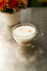 hot cappuccino coffee and orange flower