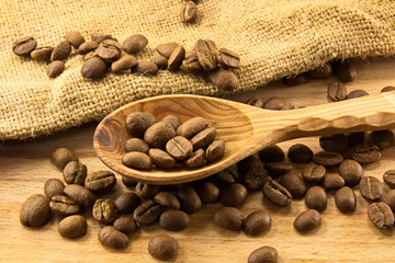 Wooden spoon and coffee on board