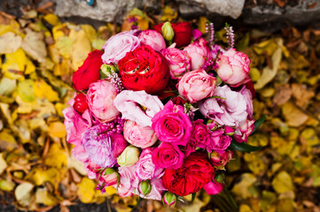 Wedding bouquet of rose and peony david austin at yellow leaves