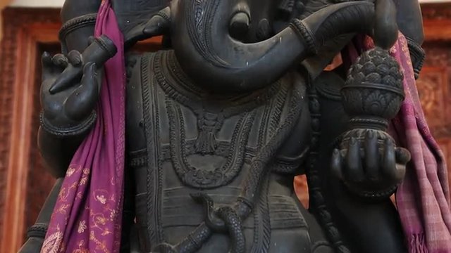 Tilt up shot of statue of Lord Ganesha at Chhatarpur Temple, New Delhi, India