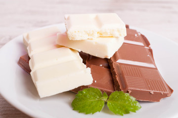 Porous white chocolate and milk chocolate on a white plate