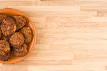 Fototapeta na wymiar Fried cutlet in the plate on wooden table