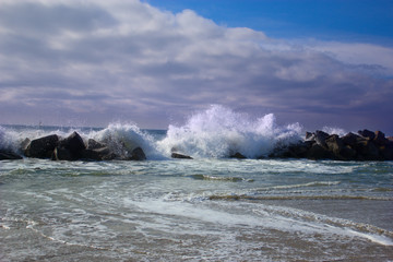 Big waves breaking against the rocks. Waves breaking over the ro