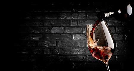 Pouring wine and brick wall
