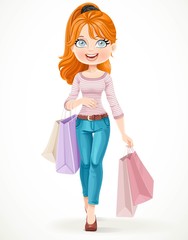 Cute redhead shopaholic girl goes with paper bags in hands isolated on a white background