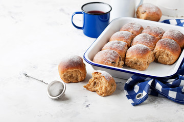 Fresh whole grain sweet buns with raisins, selective focus