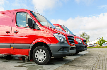 Row of two red delivery and service vans