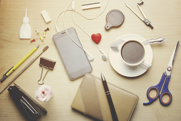 Notebook with pen, phone, coffee and stationery