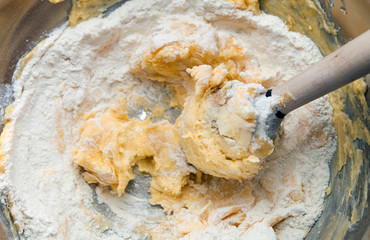 Kneading dough in mixing bowl, butter and flour