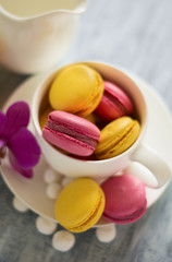 Fototapeta na wymiar Several types of macaroons with white cup