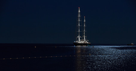 France, Menton, 28 august 2015: Large modern sailboat type Falcon standing on the lunar path at...