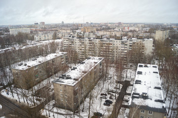 Urban landscape with snow-covered streets on a cloudy day