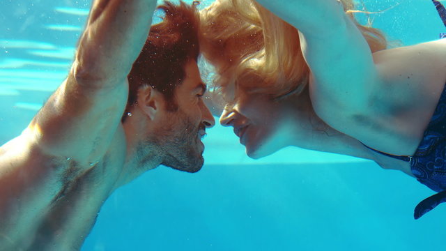 Happy couple kissing underwater