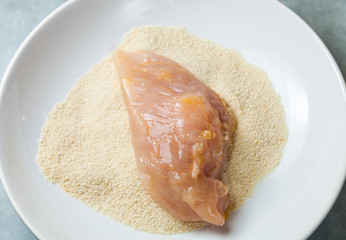 Preparing chicken breast fillets, breadcrumbs and eggs