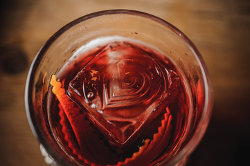 cocktail on a dark bar setting with orange zest