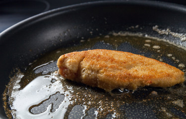 Chicken breast fillets fried in frying pan
