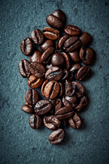 Arabica coffee beans on a stone background