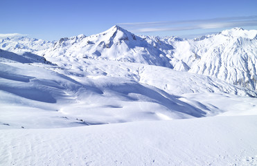 Winter rugged mountain panorama with snowy peaks and valleys, French Alps