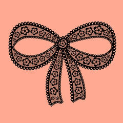 Decorative lacy bow on beige background