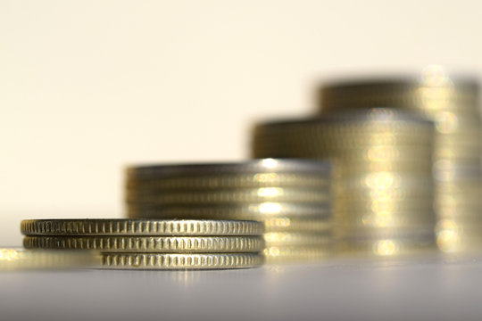 Coins stacked in bars. The concept of revenue growth