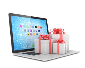 Gift box with ribbon bow on laptop keyboard