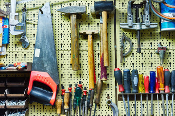 workbench with many tools / hammers, saws, screwdrivers and co