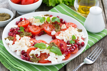 fresh salad with tomatoes, cottage cheese, mint pesto 