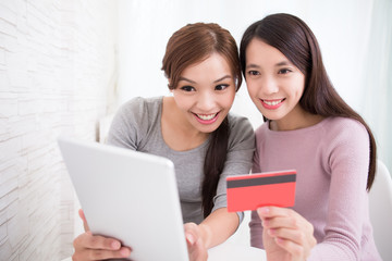 Fototapeta premium young girls shopping on internet