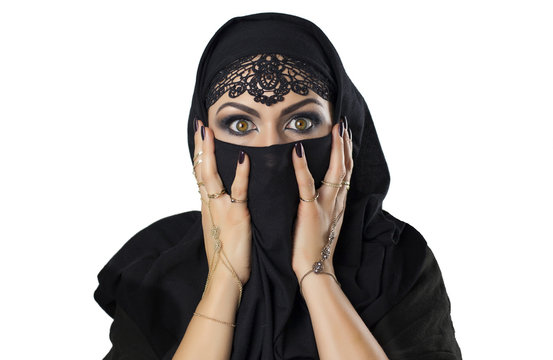 Caucasian young woman with black veil on face frightened