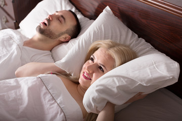 wife with husband snoring in sleep