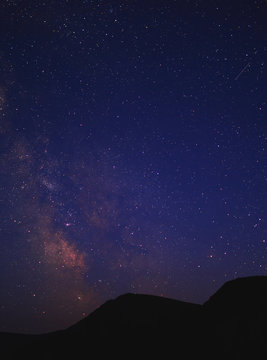 Vibrant night sky, milky way in mountains.