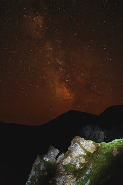 Night scene of mountain ridge and clear starry sky.