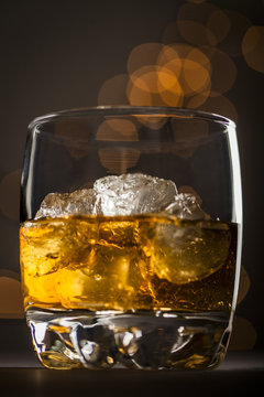 Close up of whiskey with ice cubes in glass