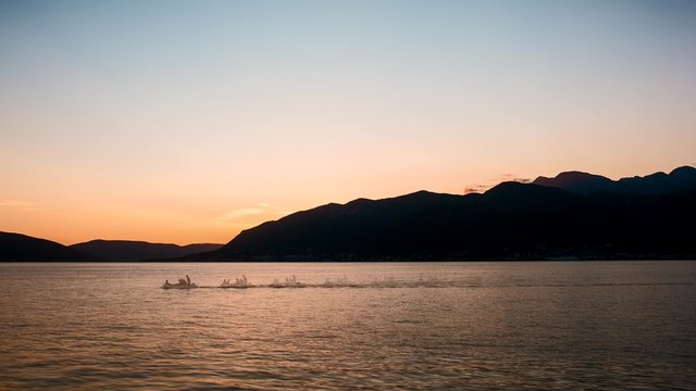 Timelapse sunset over Kotor Bay, Montenegro. Time lapse sea, mountains and sky background. Yachts and boats.