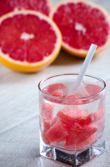 A glass of refreshing drink with grapefruit and grapefruit
