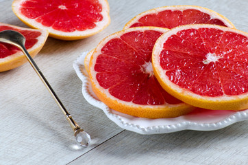 Grapefruit slices on a plate and spoon
