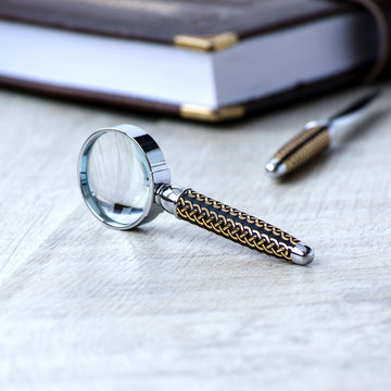 Stationery magnifier on a grey background