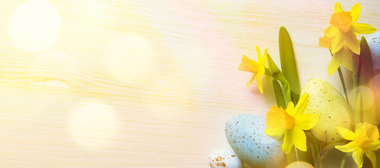 art Easter Background with easter eggs and yellow spring flowers