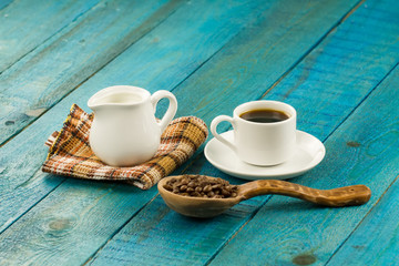 Set table for breakfast. Hot Cup of coffee on turquoise wooden background
