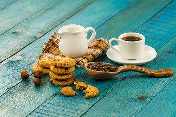 Chocolate chip cookies on an old vintage turquoise wooden background. Set table for breakfast. Hot Cup of coffee