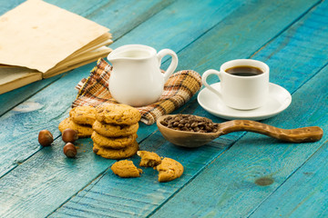 Chocolate chip cookies on an old vintage turquoise wooden background. Set table for breakfast. Hot Cup of coffee