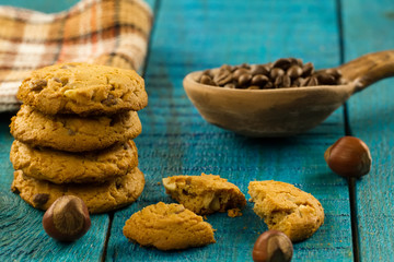 Chocolate chip cookies on an old vintage turquoise wooden background.
