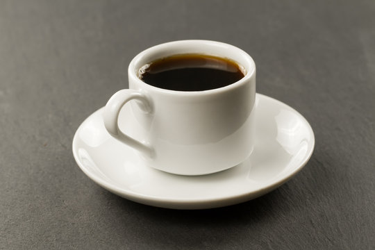 white black Cup of coffee on a black background.